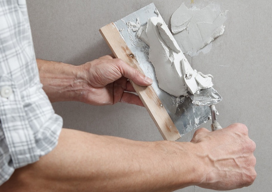 bigstock-Closeup-Hands-Man-Drywall-Work-414333320-1